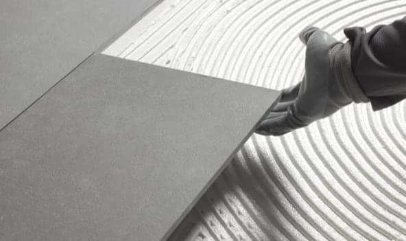 Large-format tile set into combed tile adhesive