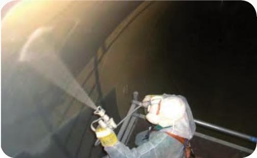 Operator in protective suit spraying AQUATA inside the shaft